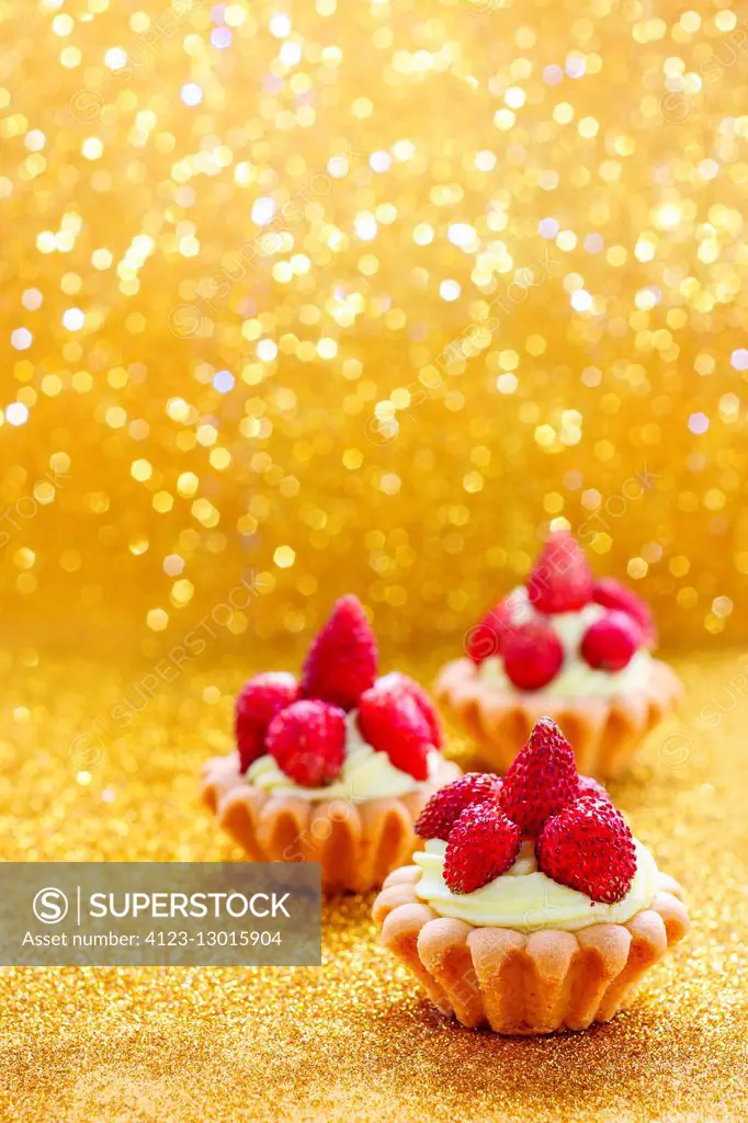 Beautiful tiny cupcakes with wild strawberries. Party dessert