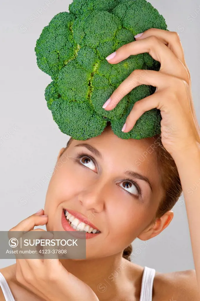 Woman holding broccoli.