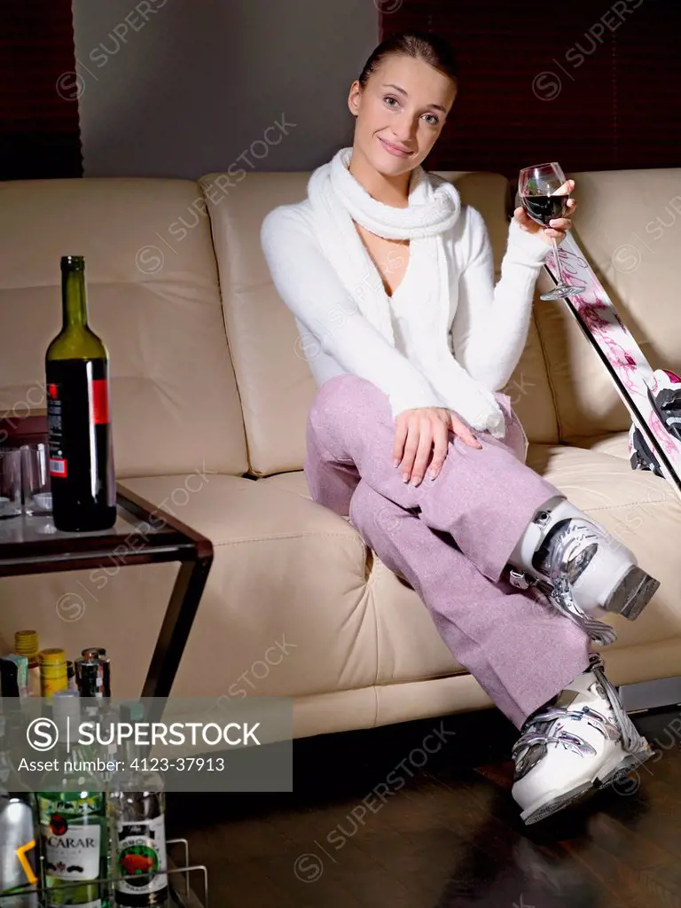 Woman drinking alcohol after skiing.