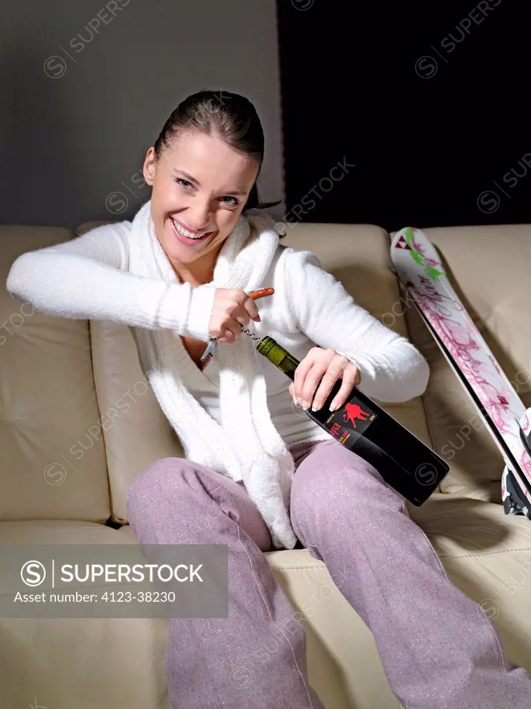 Woman drinking alcohol after skiing.