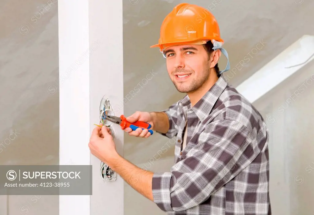 Young man using pliers.