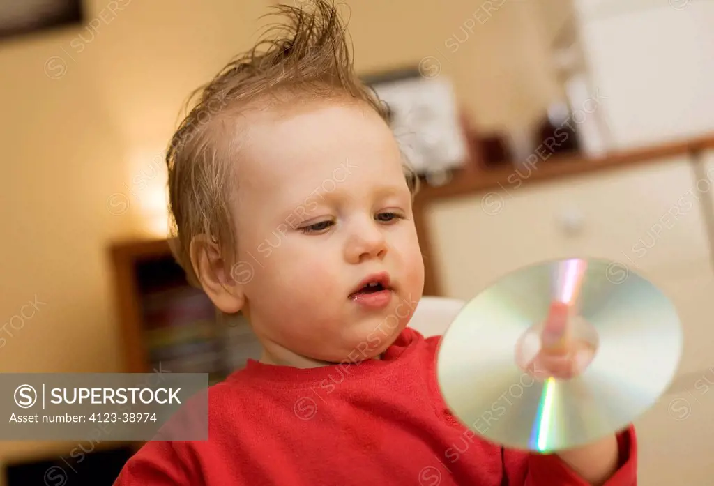 Baby playing with compact disc.