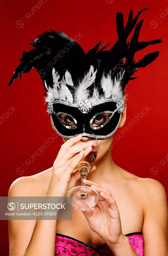 Young woman wearing a carnival mask.