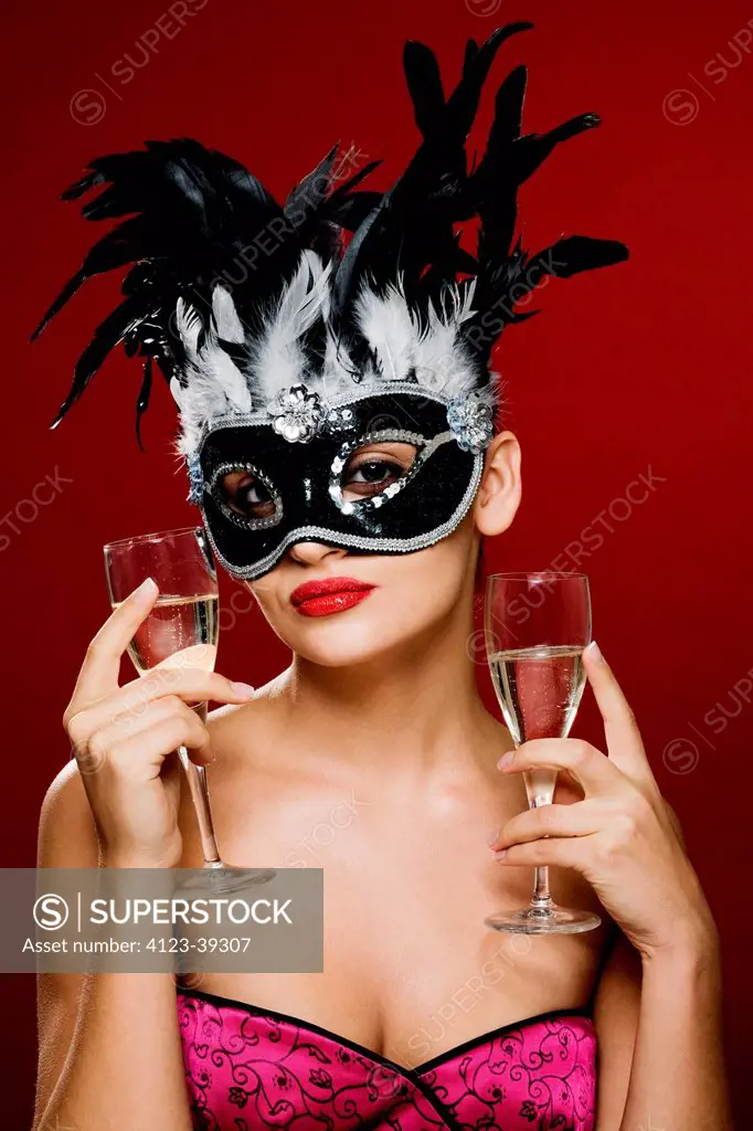 Young woman wearing a carnival mask.