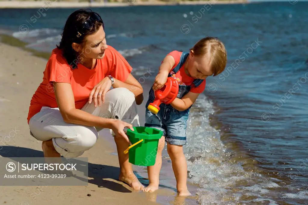Little girl with mother at the sea.