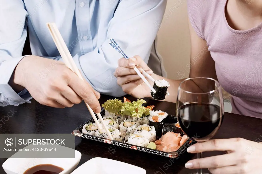 Young couple while eating sushi