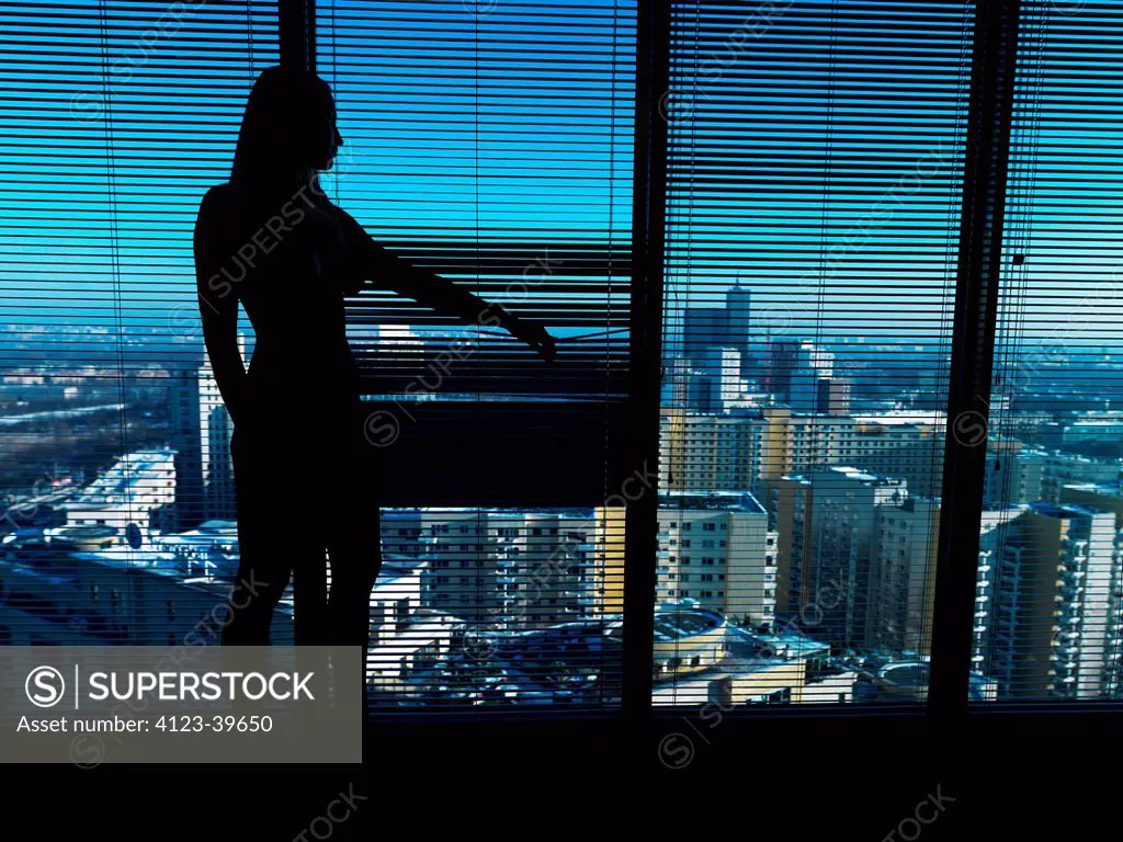 Young woman looking out the window