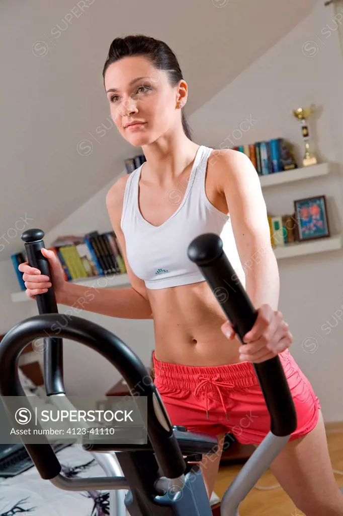 Woman doing exercises on stepper.
