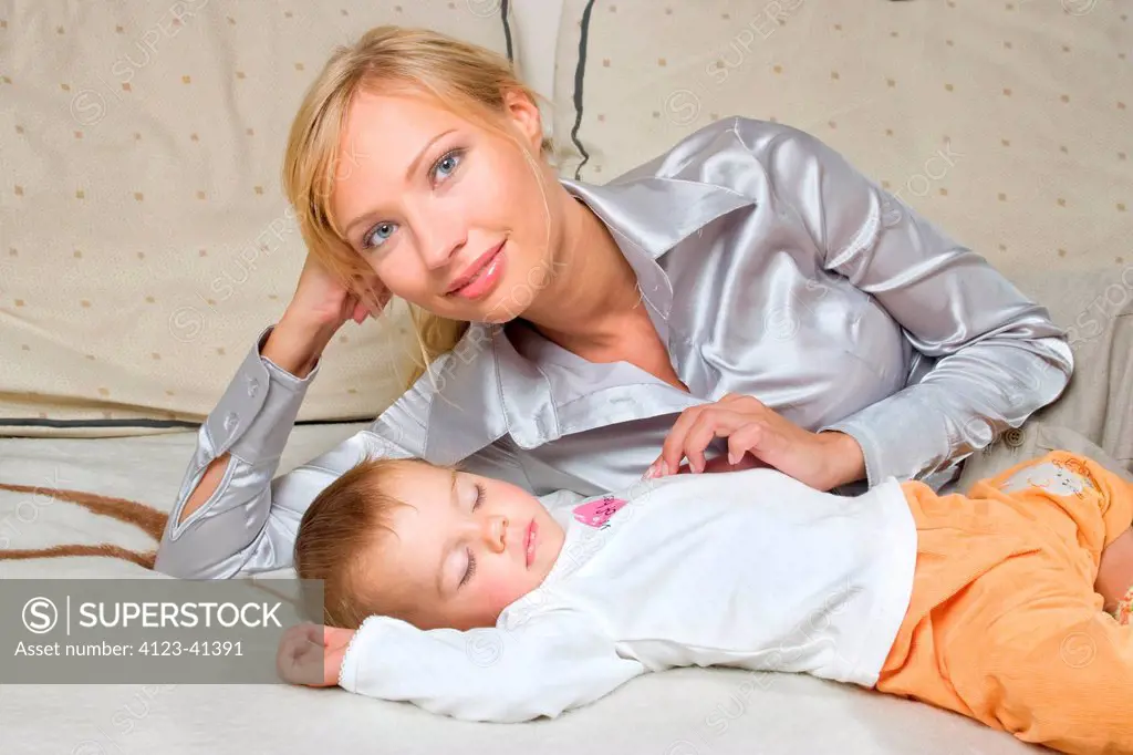 Young woman lying with a child.