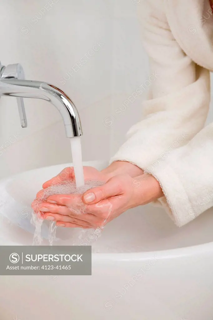 Woman cleaning hands.