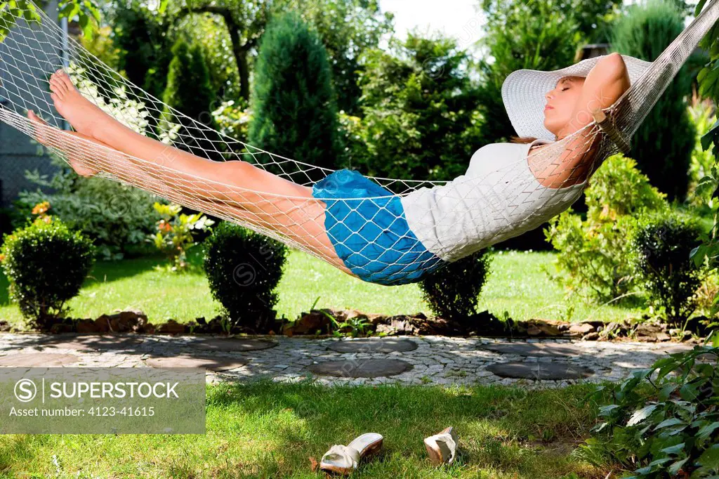 Woman resting on hammock.
