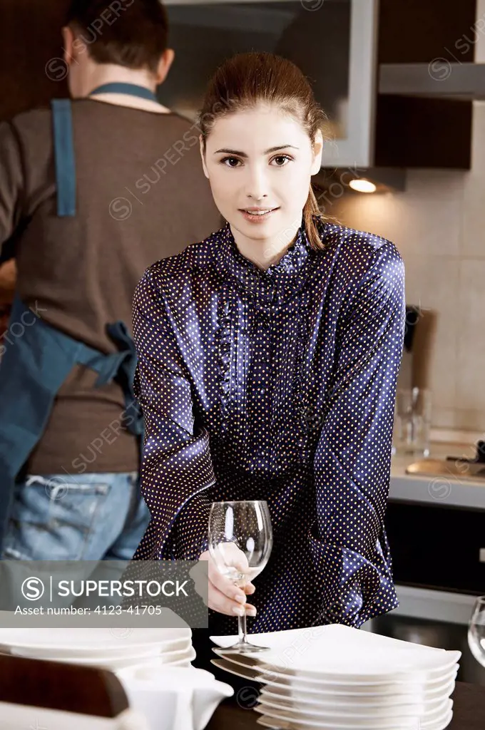 Woman wiping dishes in the kitchen