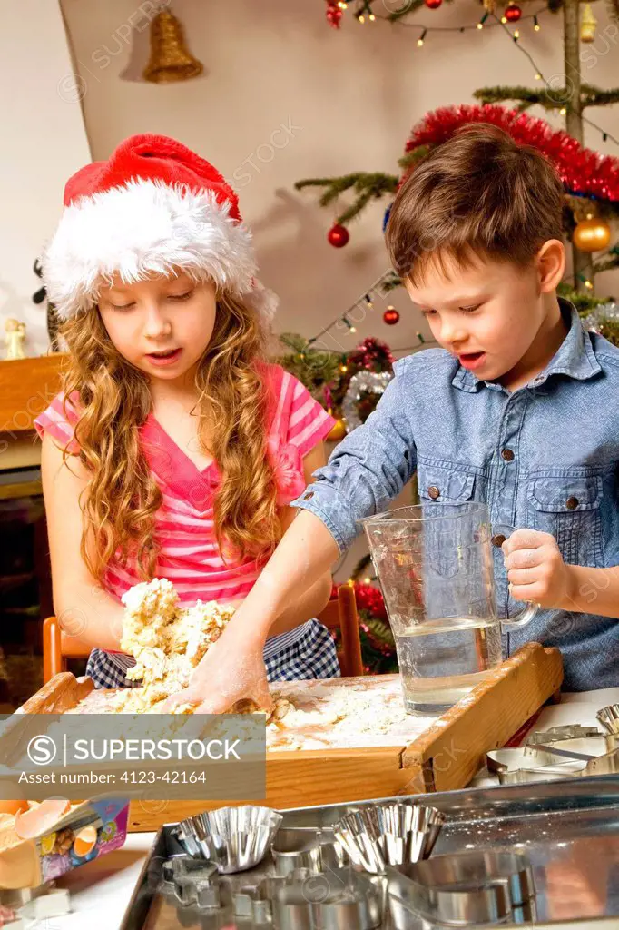 Children making Christmas cake.