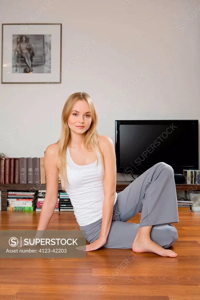 Young woman exercising in the living room