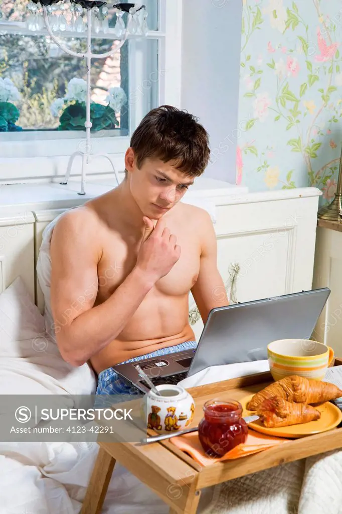 Young man spending morning in bed.