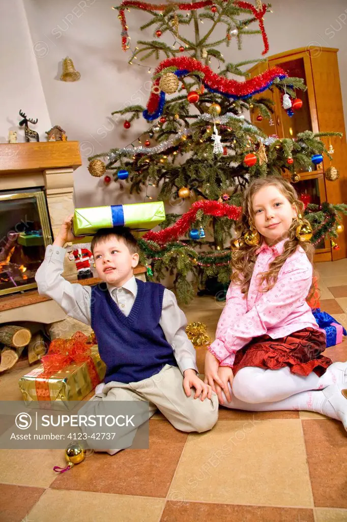 Children sitting with presents.