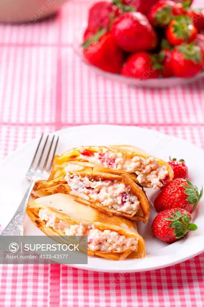 Crepes with cottage cheese and strawberries.