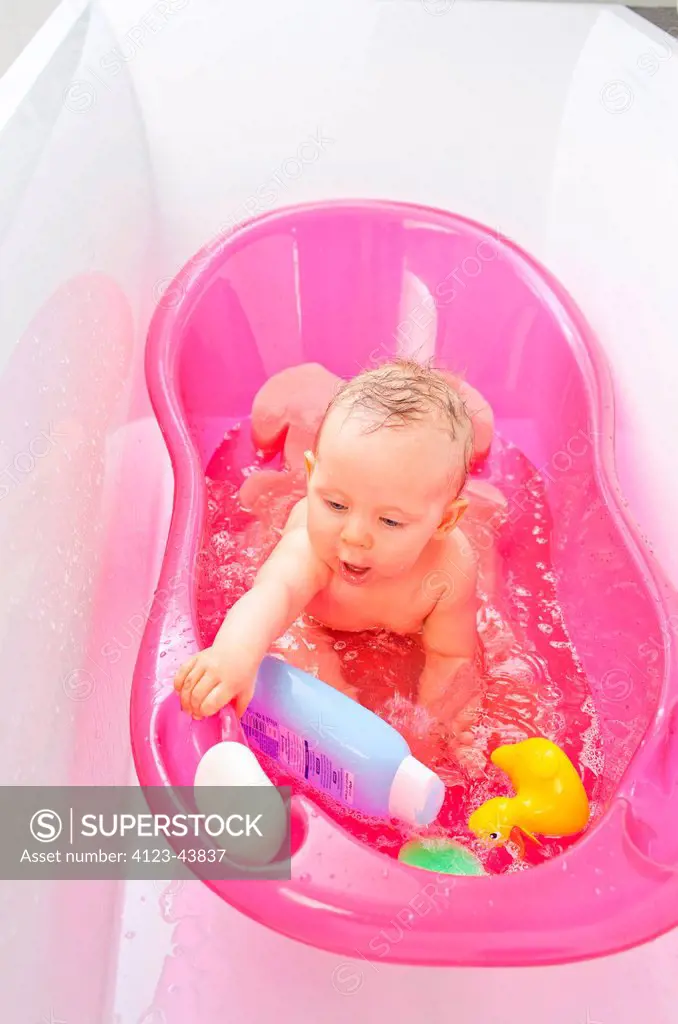 A baby taking a bath.