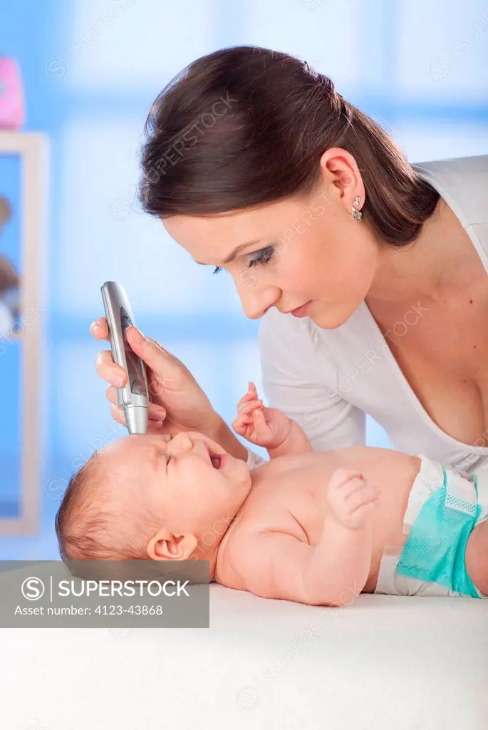 Woman measuring her baby's temperature.