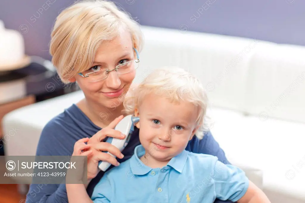 Woman measuring her child's temperature.