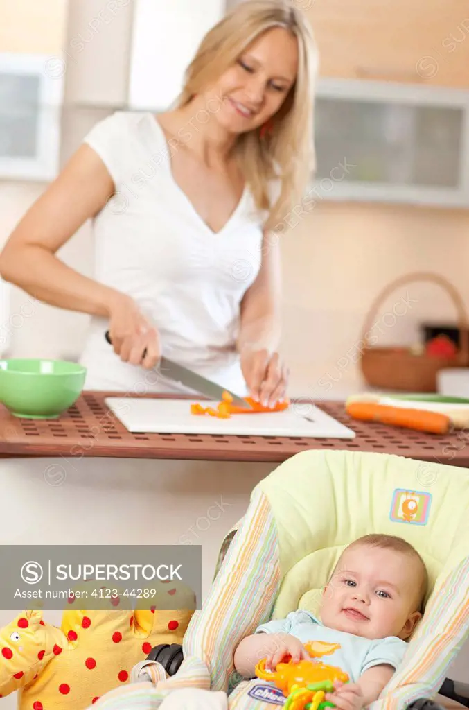 Young woman making a meal for her child.