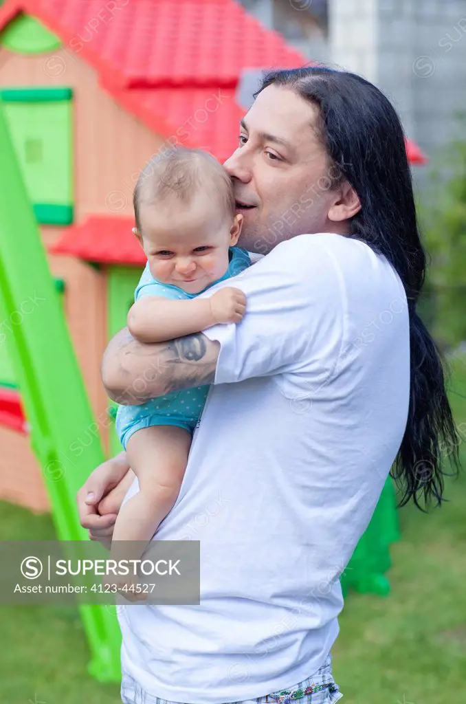 Father spending time with his child in the garden.