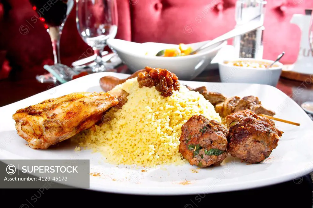 Meal from North Africa- lamb, skewer, couscous, sausage.