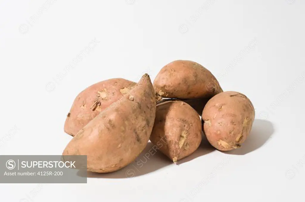 Organic Sweet Potato Yams in pile on white background