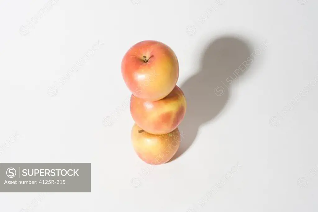 Organic empire apples stacked up balanced on white background