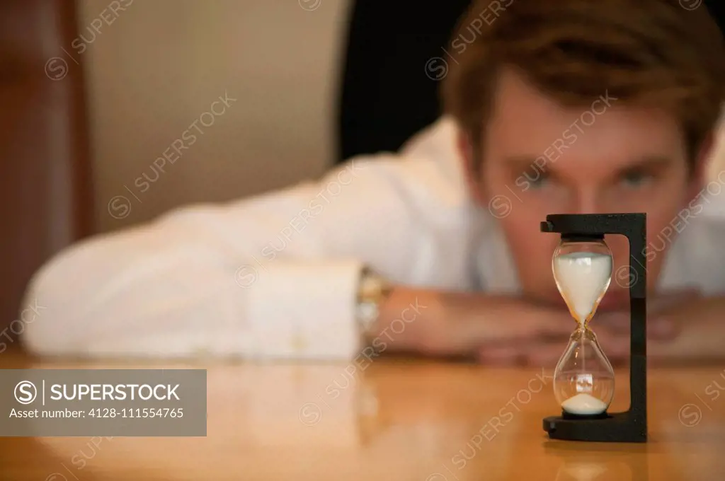 Businessman watching sand timer