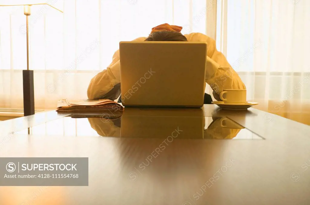 Businessman behind laptop