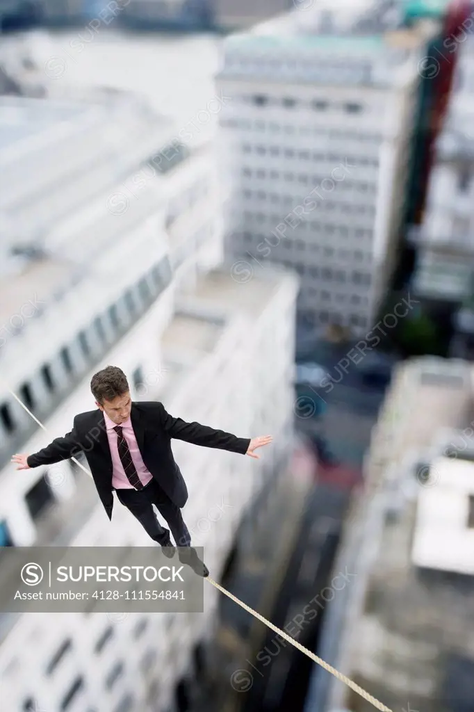 Businessman walking on a tightrope