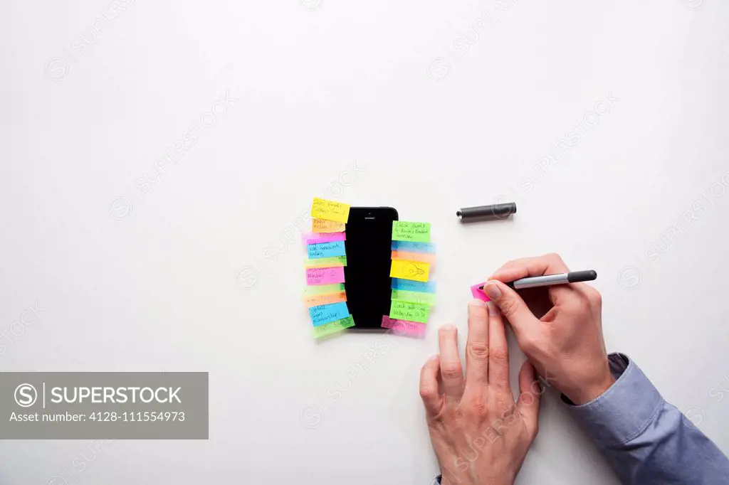 Smartphone covered in sticky notes