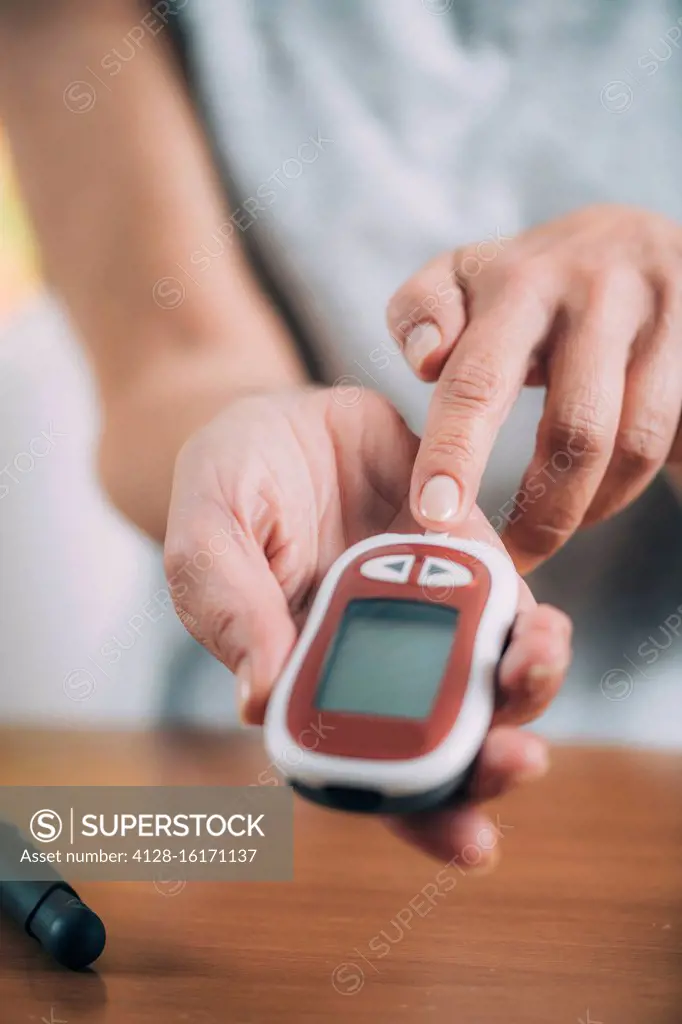 Blood sugar monitor testing at home.