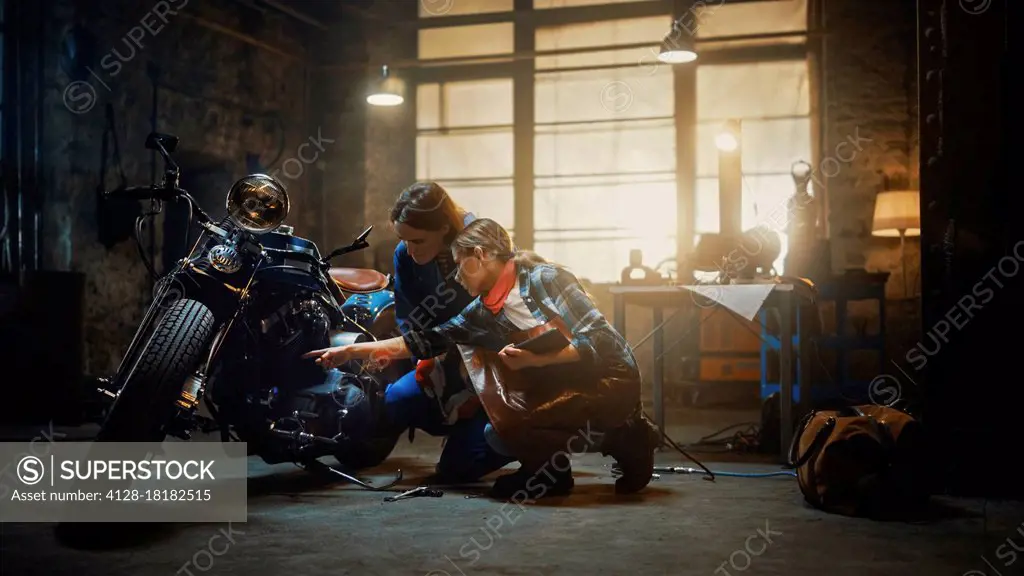 Mechanics discussing work done on a custom bobber motorcycle