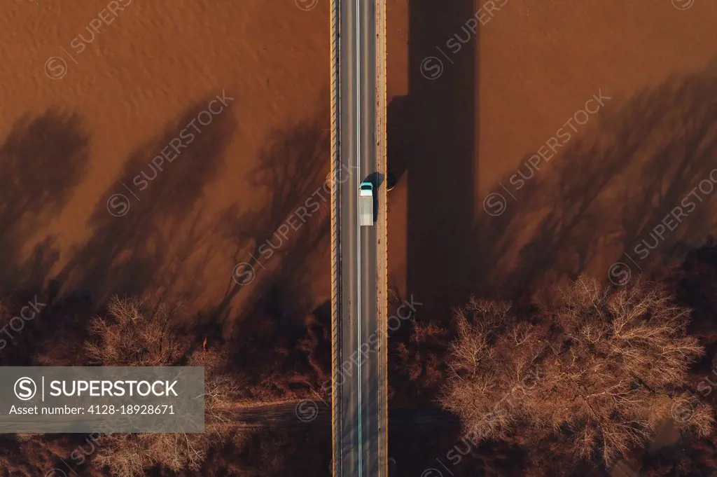 Vehicle crossing bridge, aerial view