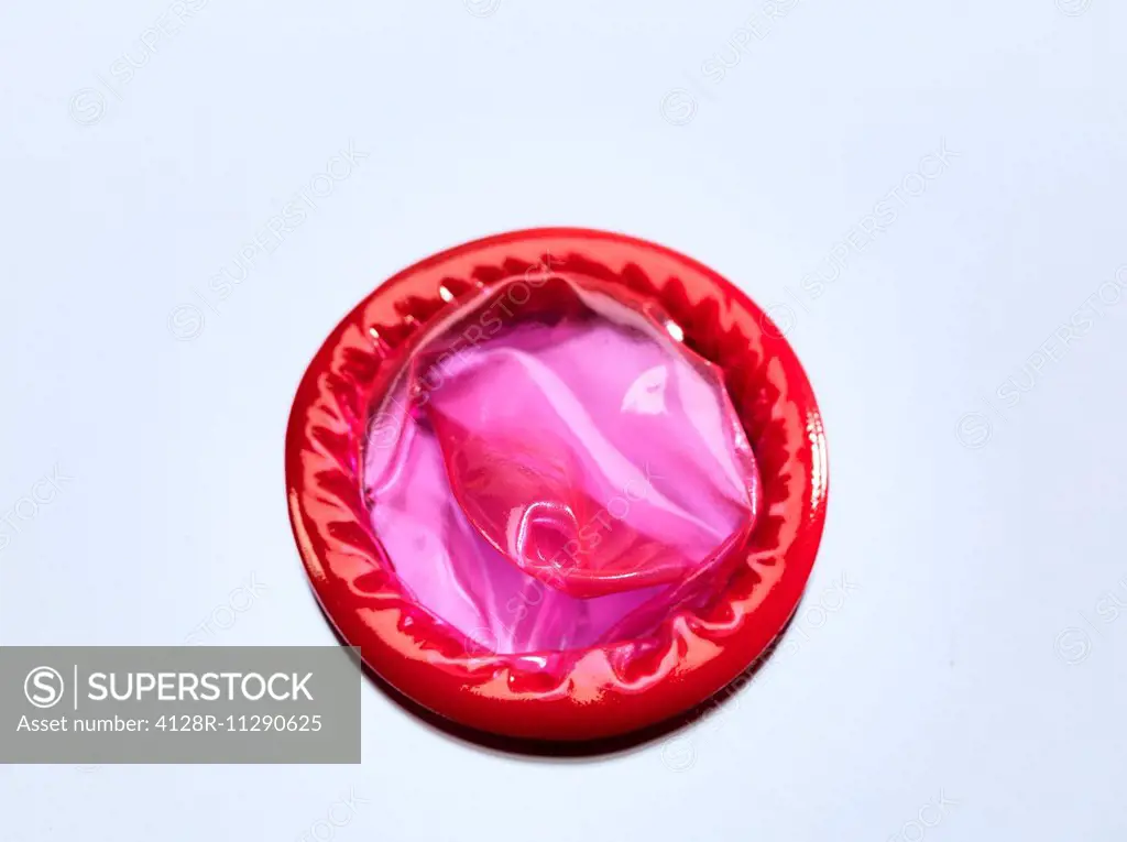 Red condom, studio shot.