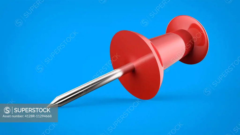 Red push pin against a blue background.
