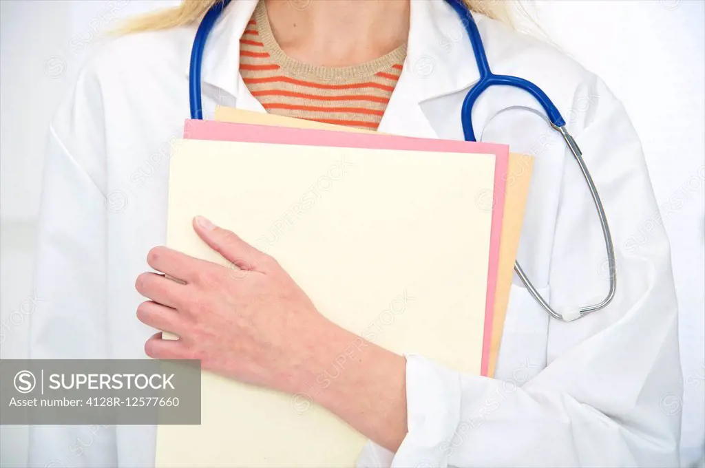 Doctor with a stethoscope around her neck holding medical notes.