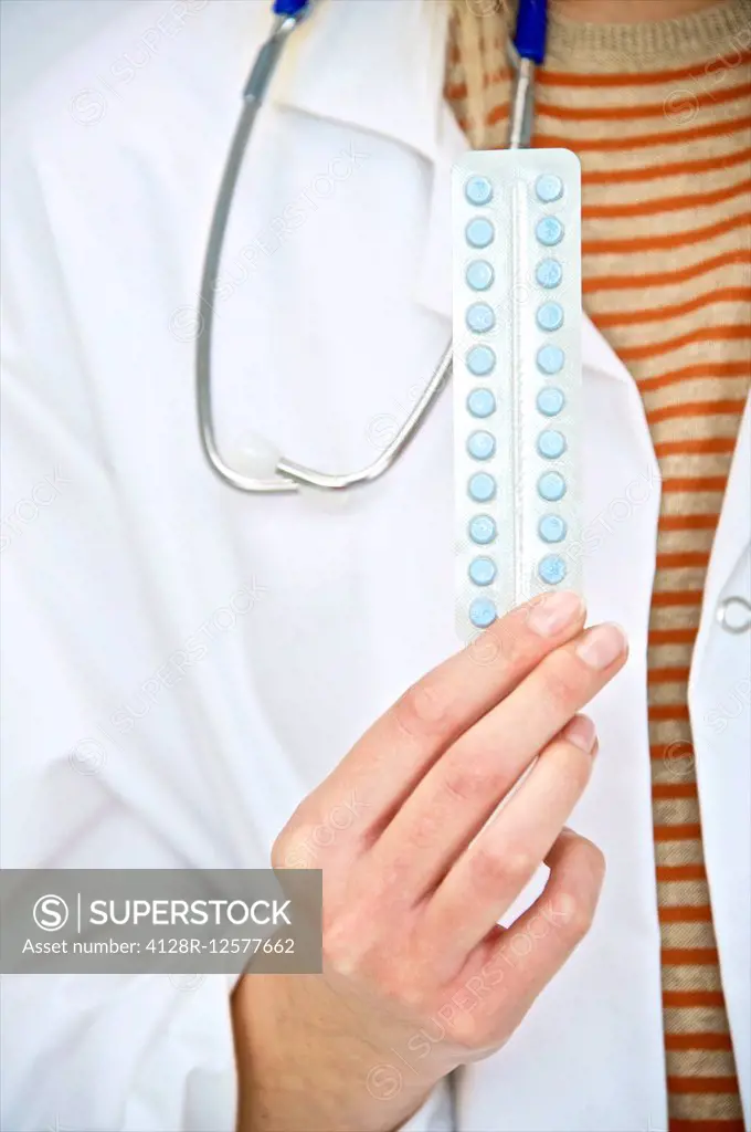 Doctor holding oral contraception pills, close up.