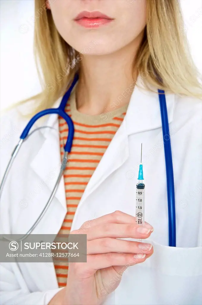 Female doctor holding a syringe.