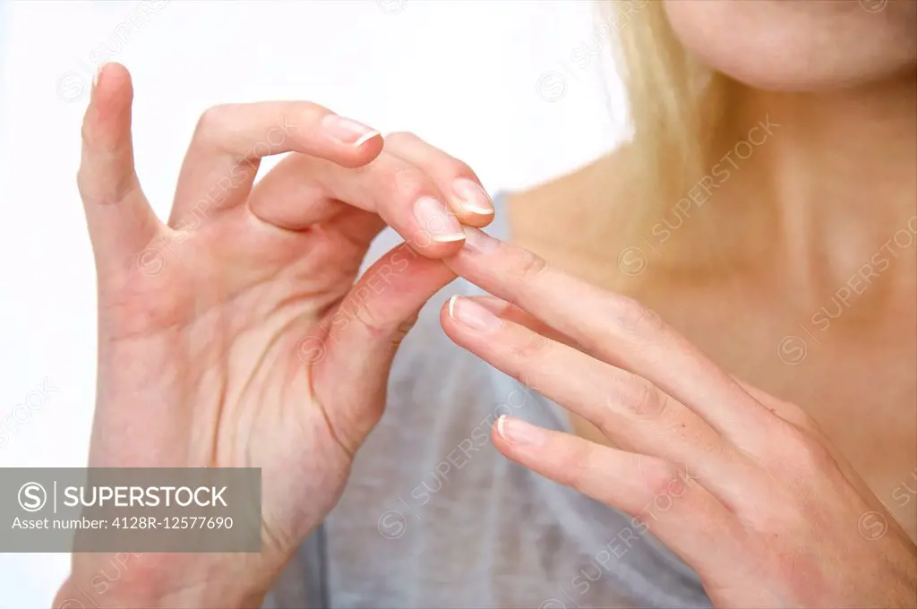 Young woman touching her finger.