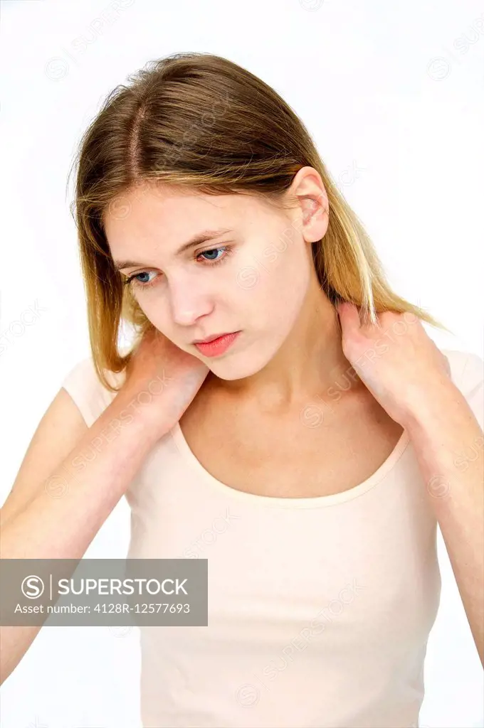 Young woman touching her neck.
