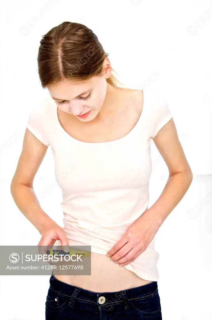 Woman using a puregon injection to treat infertility.