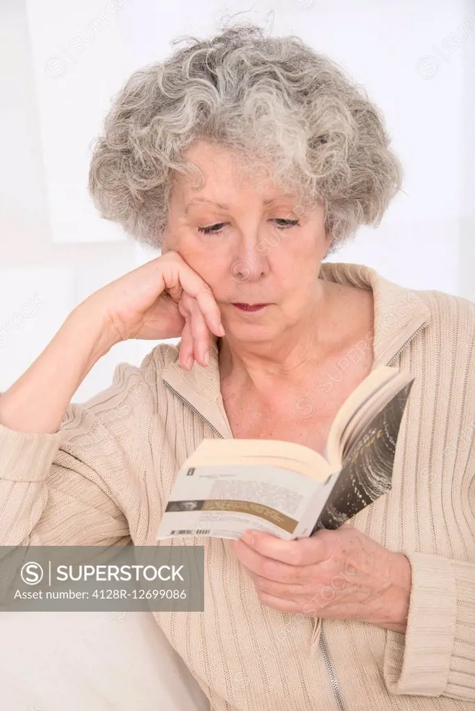 MODEL RELEASED. Senior woman reading a book.