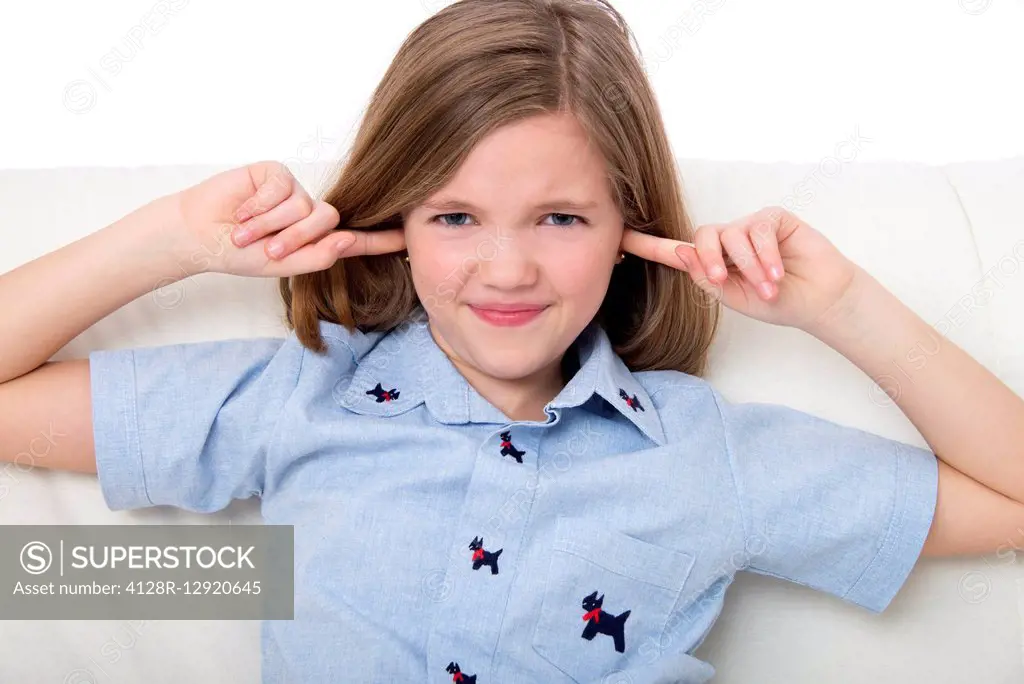 Girl with her fingers in ears