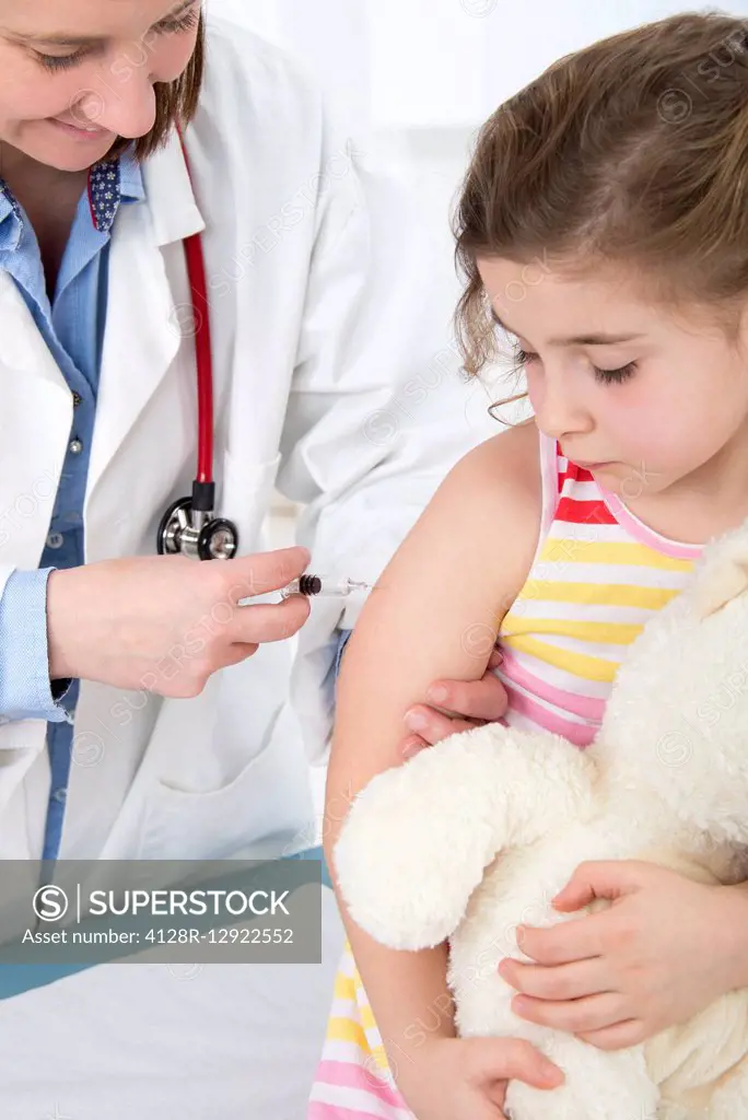 Doctor giving girl an injection