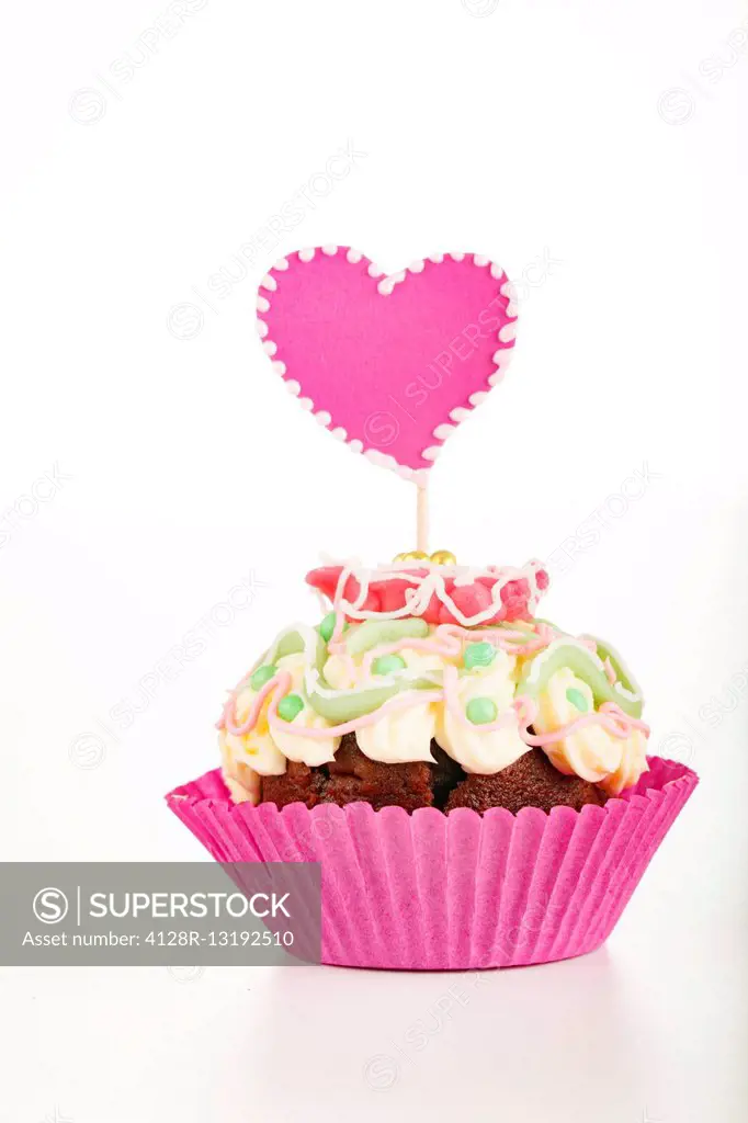Cup cake with heart decoration.