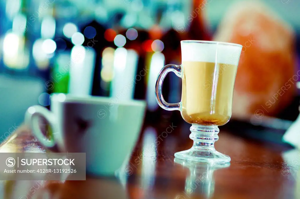 Irish coffee and teacup on the bar.
