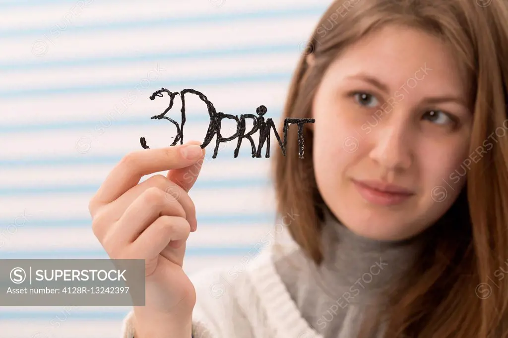 Young woman holding a 3D printed sample.